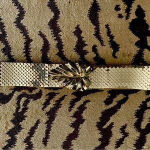 Gold stretch sequin belt with gold leaf buckle. Buckle is 3”W x 2.5”H.